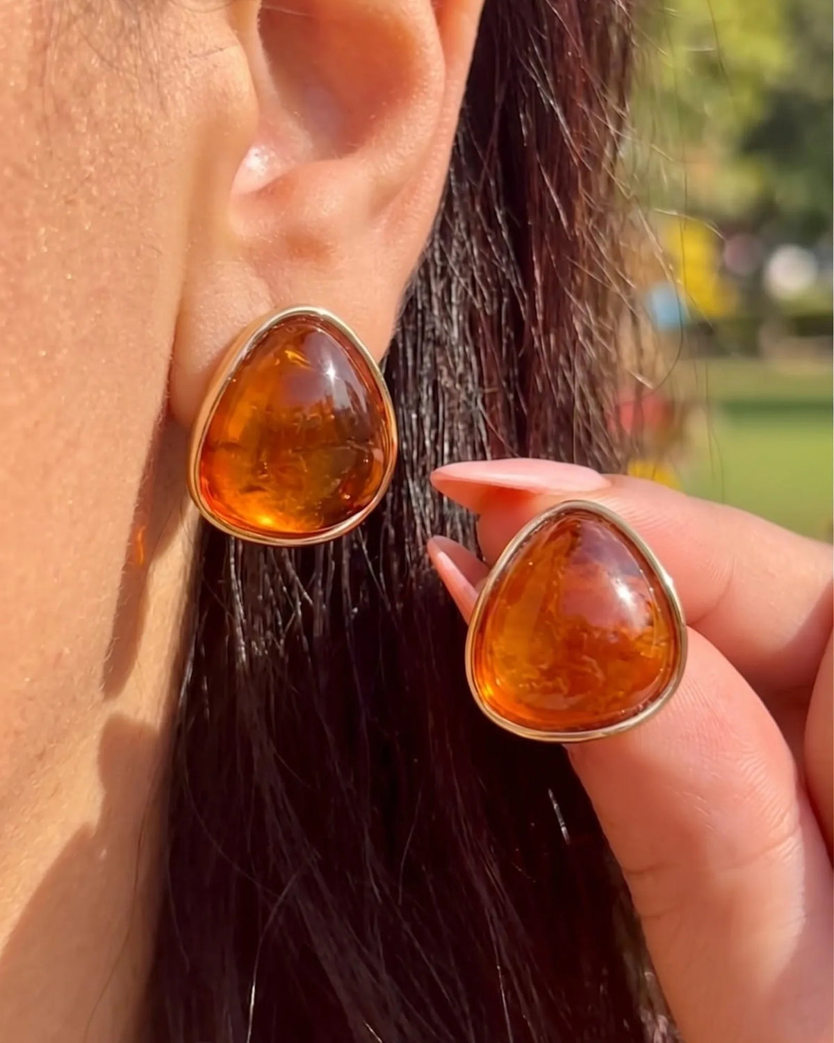 Gold-rimmed amber cabochon stud earrings