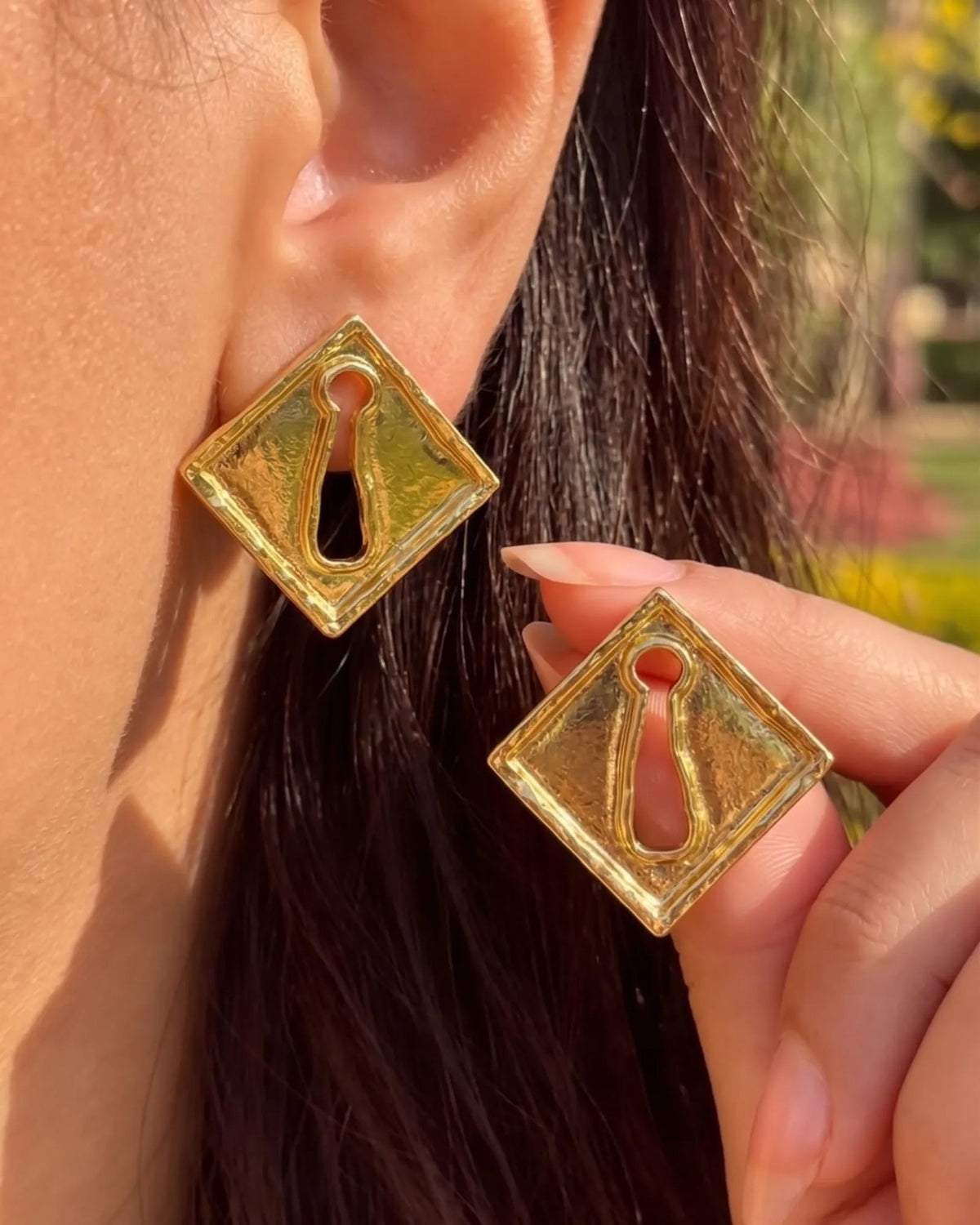 Gold diamond-shaped keyhole stud earrings with hammered texture