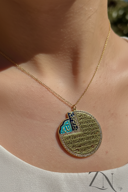 Round gold pendant necklace with Ayat Al-Kursi engraving and deep blue enamel detailing.