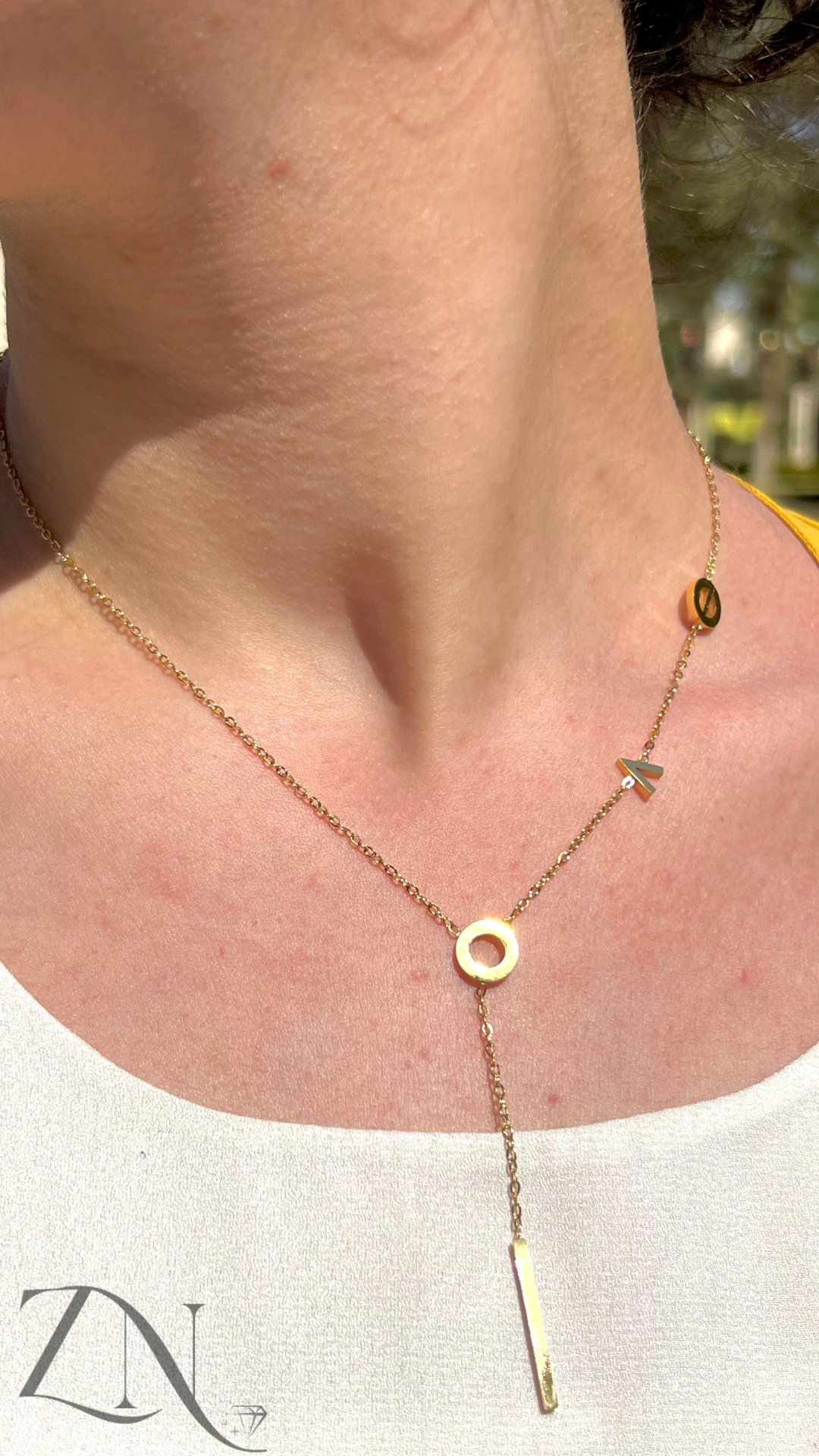 Gold-plated necklace with delicate L.O.V.E letter charms on a fine chain.