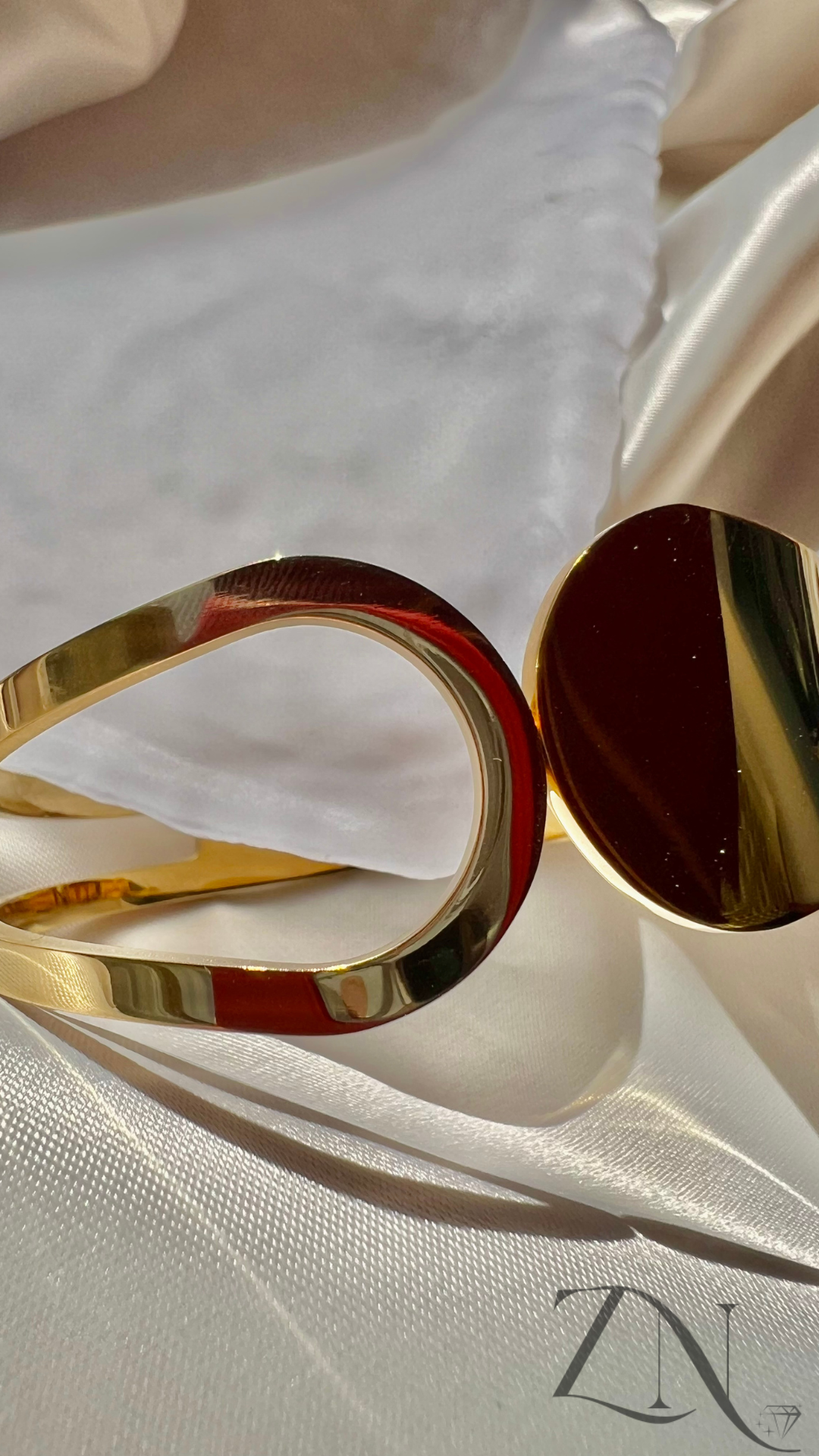 Sleek gold-tone bangle with a contemporary minimalist open design.