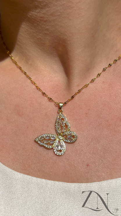 Delicate gold butterfly pendant necklace with subtle sparkle, displayed on neutral background.