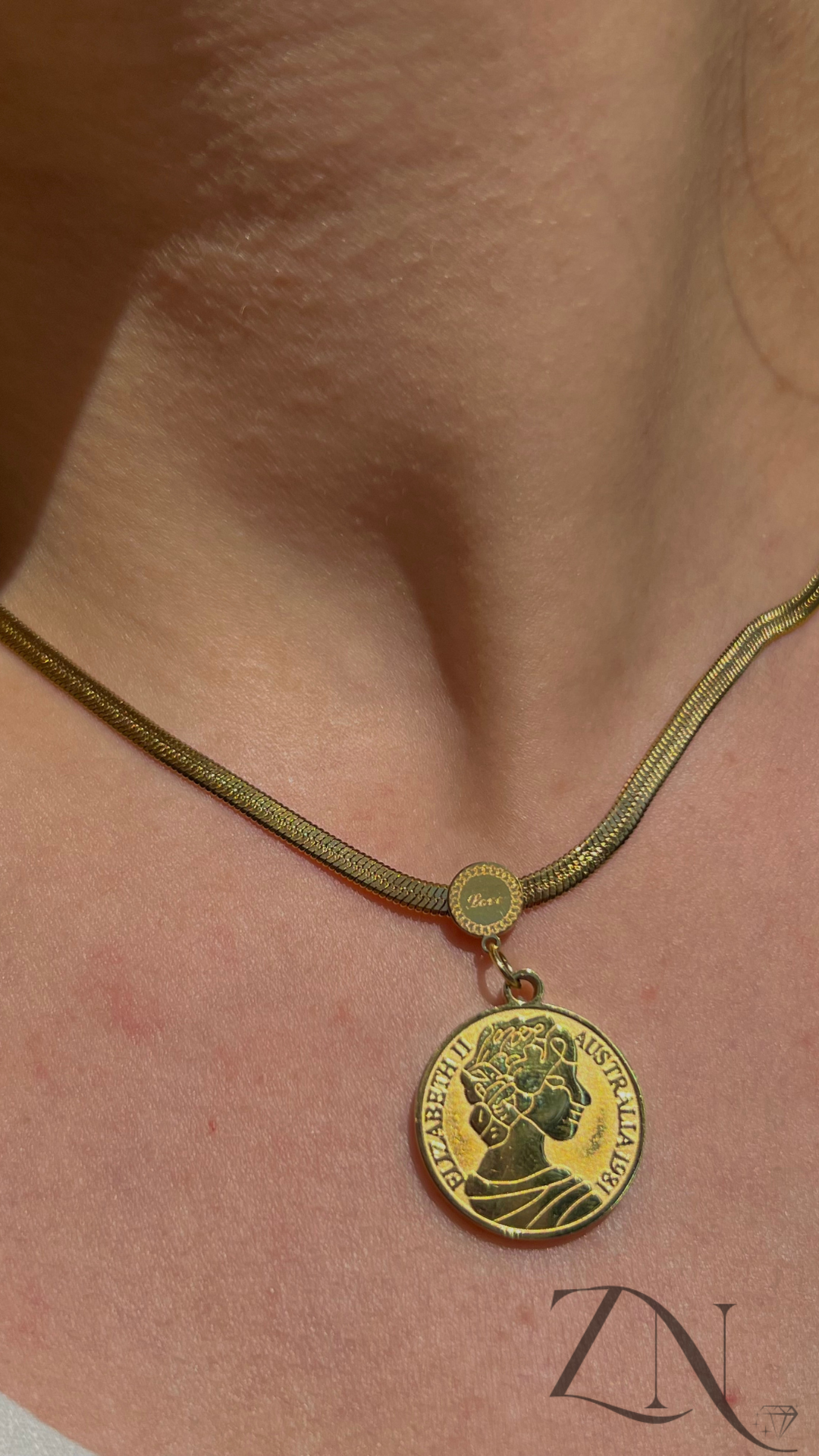 Stainless steel vintage-style coin pendant necklace featuring an antique-inspired profile design.