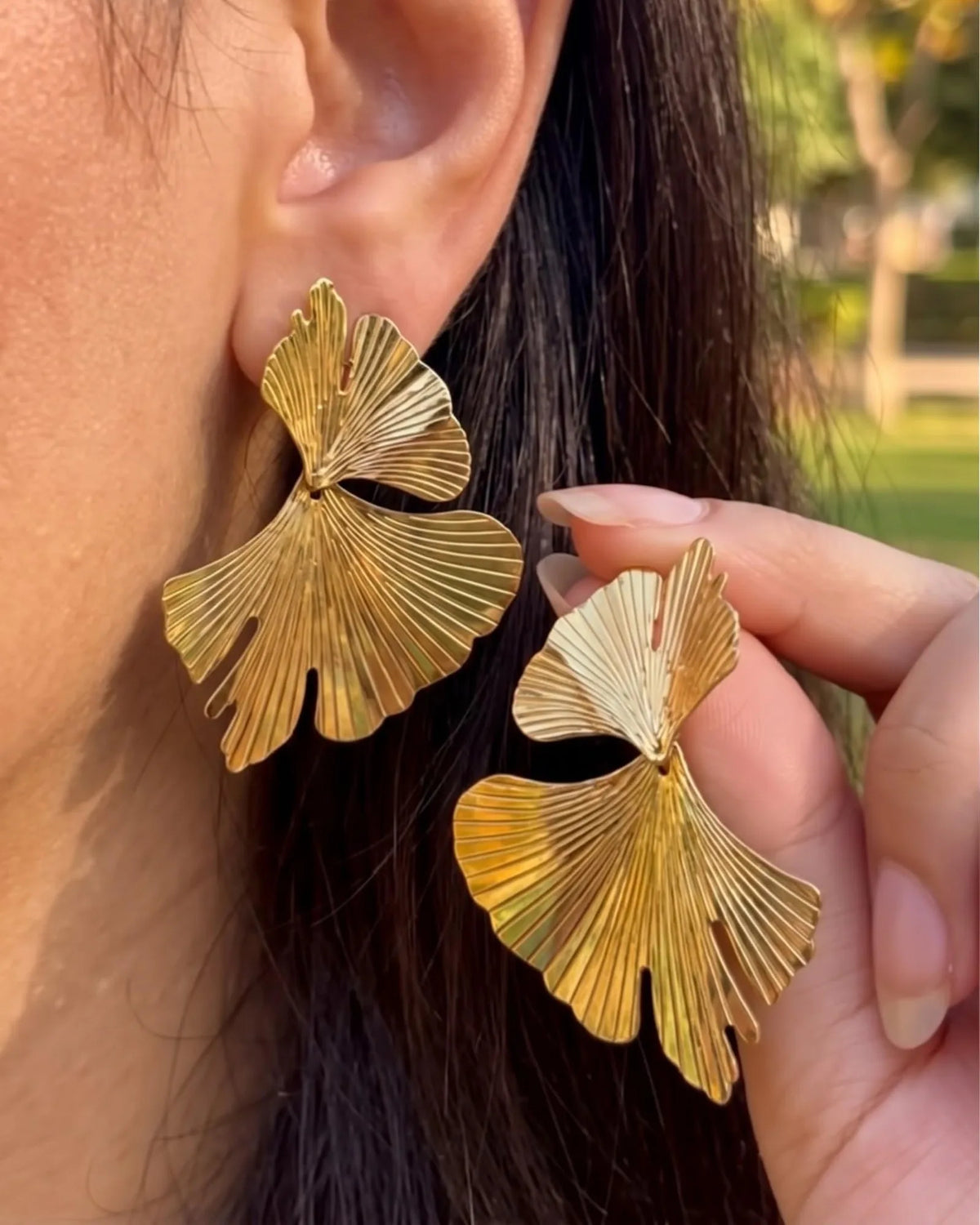 Gold double ginkgo leaf statement earrings with fine ribbed texture