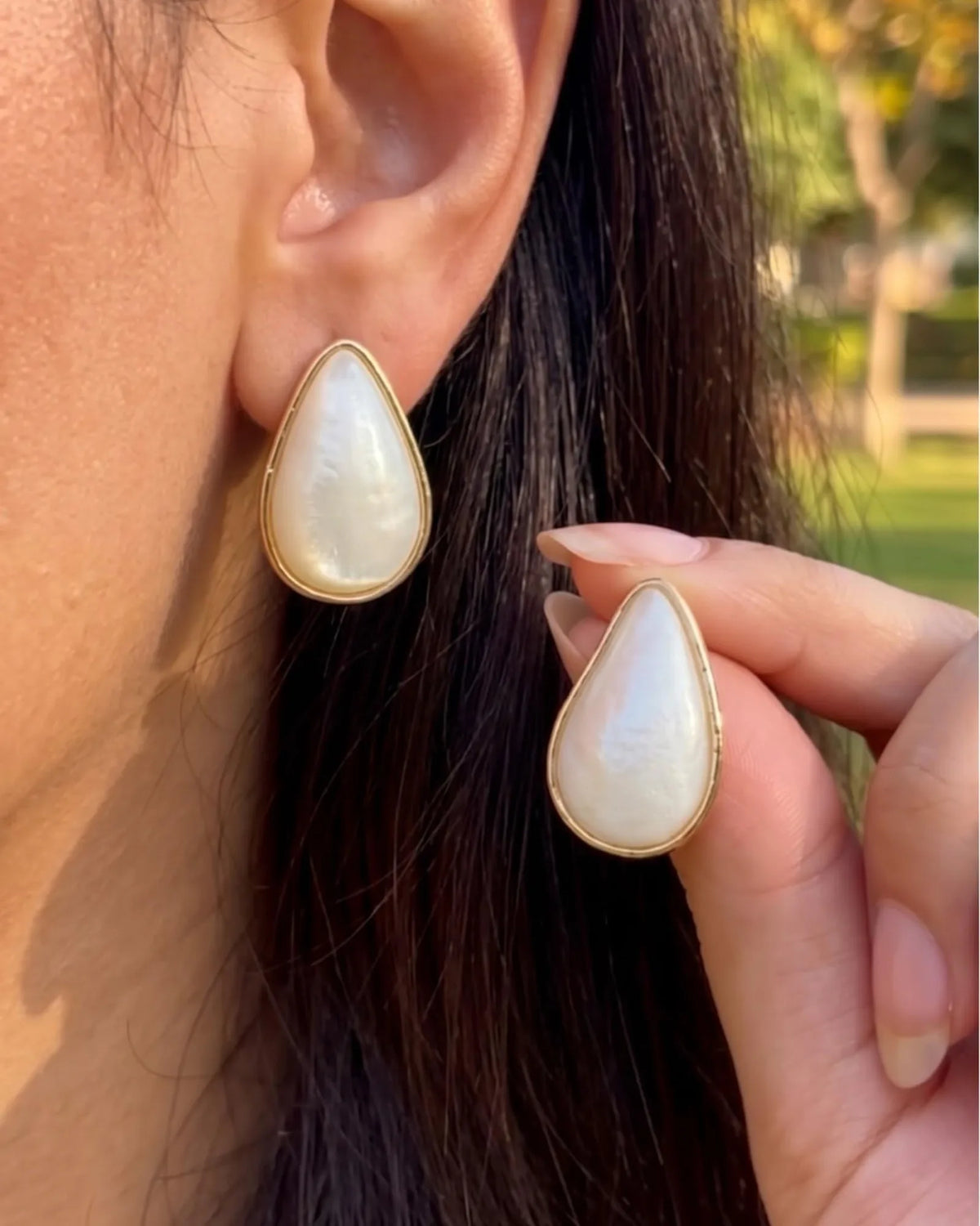 Gold-rimmed mother-of-pearl teardrop stud earrings
