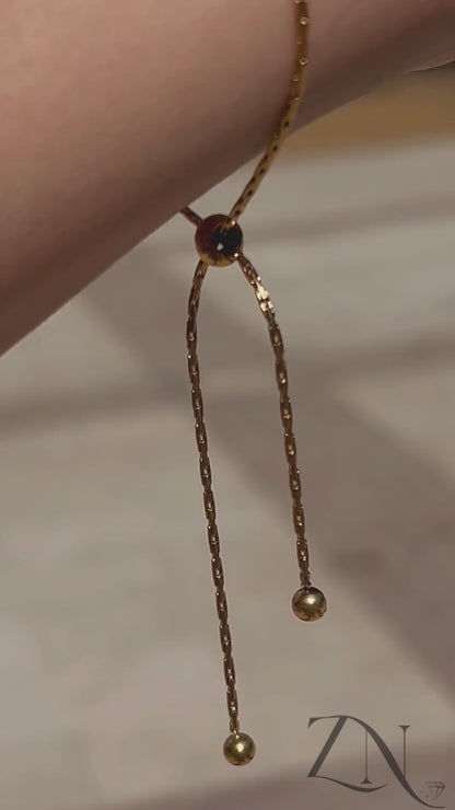 Romantic heart-link gold bracelet styled on wrist in soft lighting