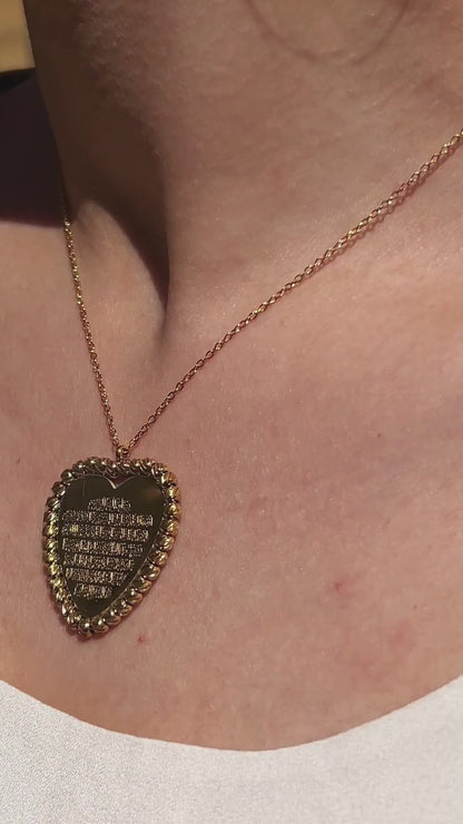 Elegant Ayat Al-Kursi heart pendant necklace shown up close, highlighting engraved Arabic calligraphy and shine.