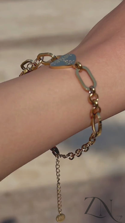 Elegant gold lock bracelet inspired by Tiffany-style design, shown on wrist in natural light.