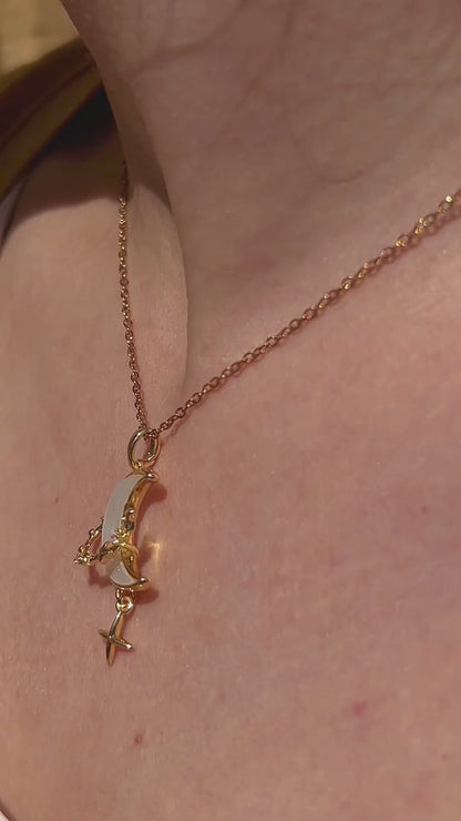 Celestial moon and star necklace shown worn, highlighting its dreamy design and gold shimmer.